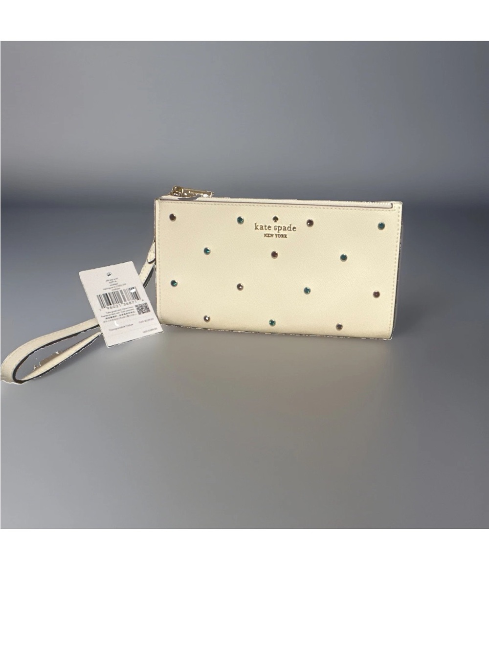 kate spade cream wristlet with multicolor stud accents